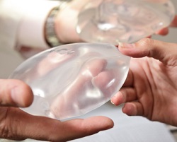 A plastic surgery patient choosing a silicone breast implant size